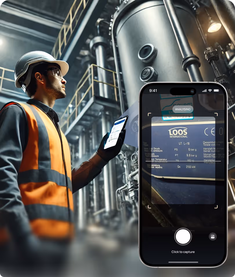 Engineer in an industrial plant using a smartphone app to analyze equipment data on a large metal machine.